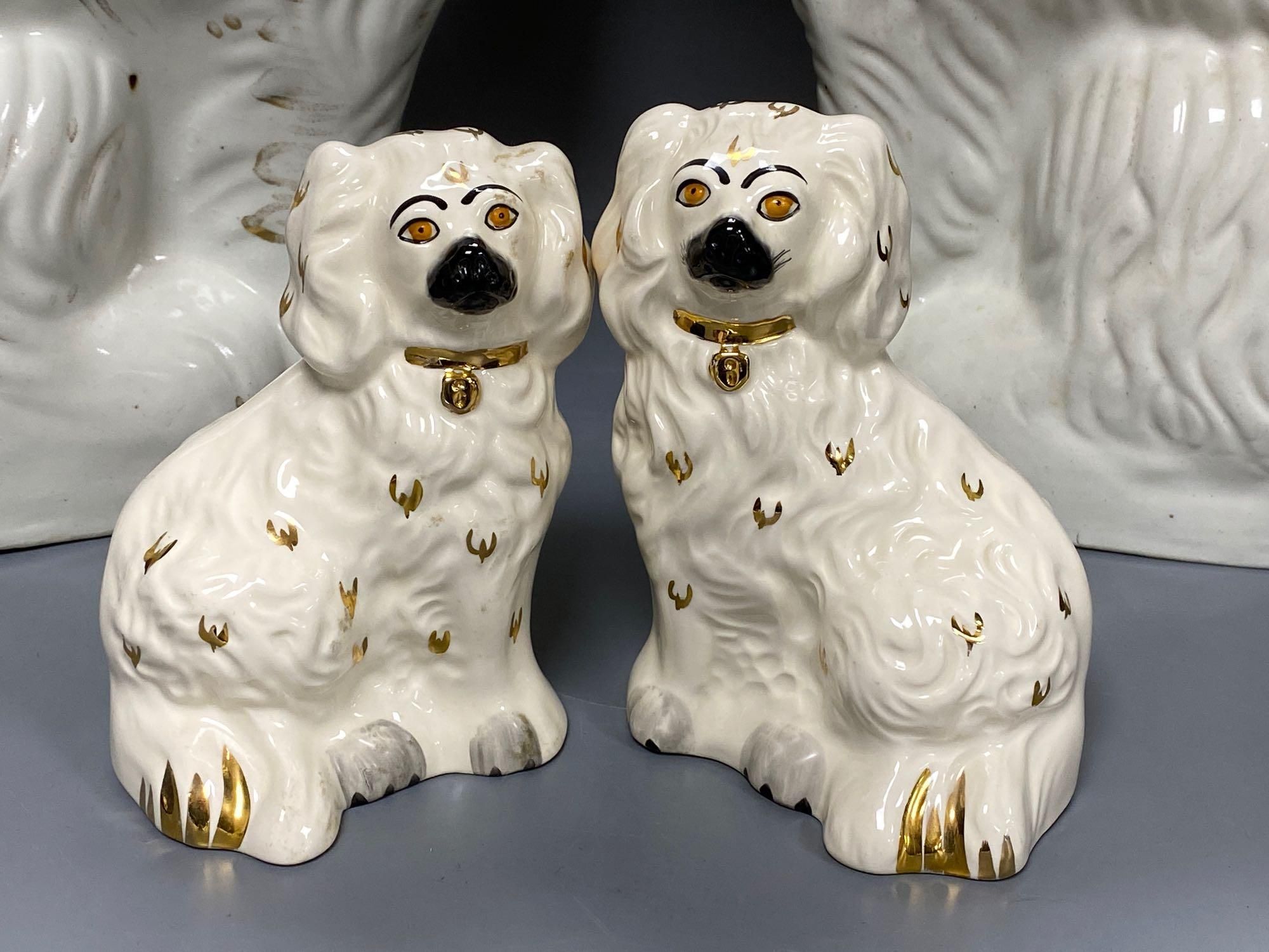 A large pair of Victorian Staffordshire pottery comforter spaniels, 39cm and a pair of Royal Doulton comforter spaniels, 14cm